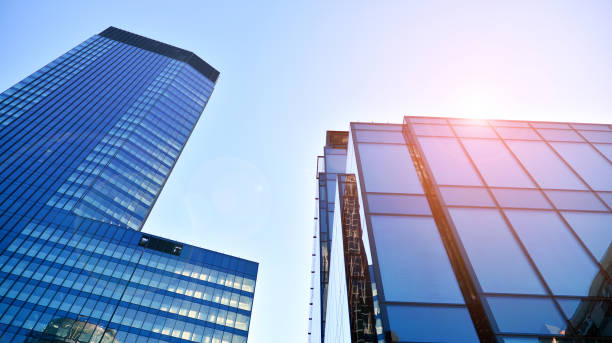 istock Commercial building close up in blue tone. Gigantic skyscraper from below. 1366377911