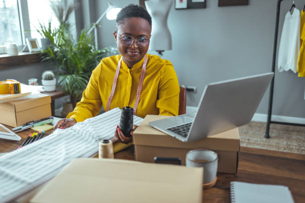 istock Female Fashion designer using laptop in studio 1366379319
