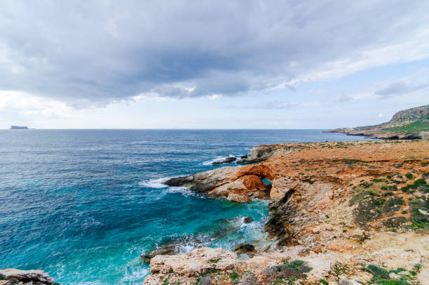 istock Natural stone arch on a coast of Malta 1366379328