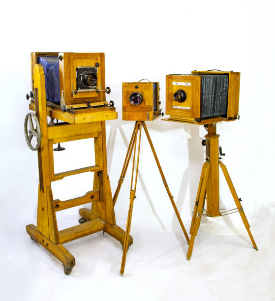 istock Three vintage large wooden cameras on a white background 1366379435