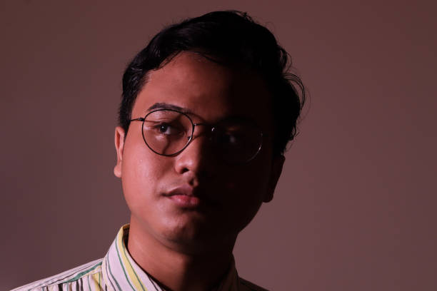 istock Asian man in casual shirt. Low light image portrait 1366380231
