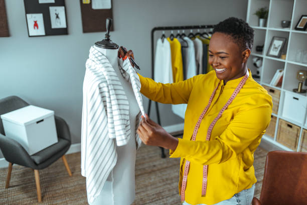 istock Tailor adjusts garment design on mannequin in workshop 1366380282