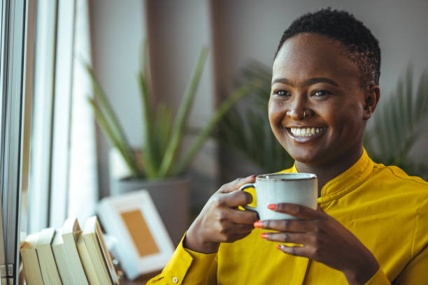 Thoughtful businesswoman holding coffee cup