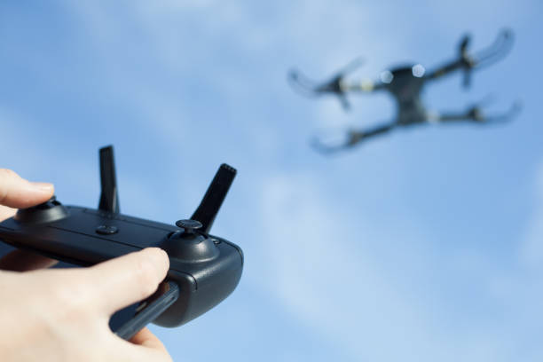 man operating drone using wireless controller man operating drone using wireless controller drone point of view stock pictures, royalty-free photos & images