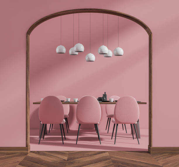 istock Bright living room interior with six pink armchairs, dining table 1366382029
