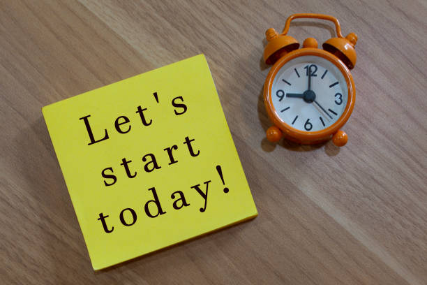 istock Lets start today - message with advice on yellow notepad with alarm clock 1366382045