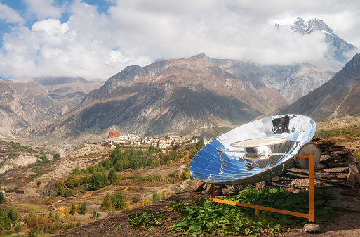 Solar cooker in Nepal Himalayan landscape. Use of renewable energy, ecology concept