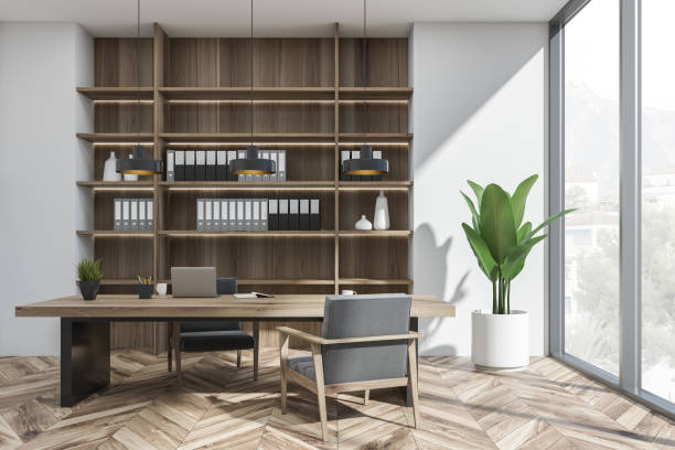 istock Bright office room interior with desk, two comfortable armchairs, laptop 1366383297
