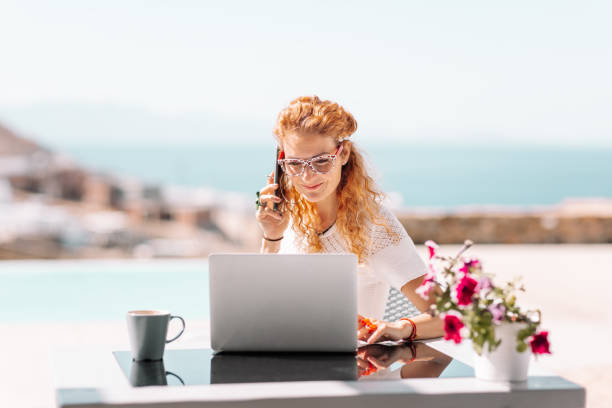 istock Business woman using laptop on terrace 1366383383