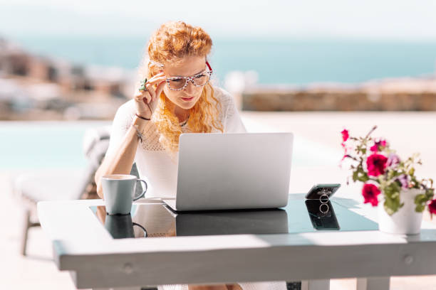 istock Business woman using laptop on terrace 1366383438