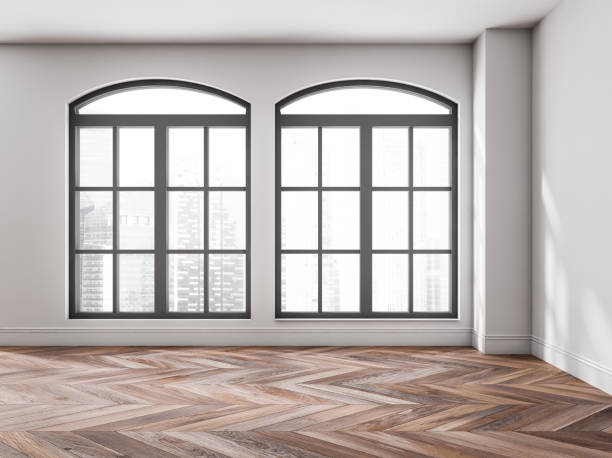 istock Empty white living room with arched windows 1366383540