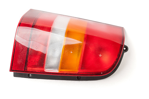 Close-up on an isolated generic rear light of a car on white background.