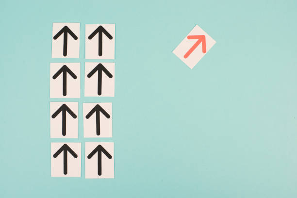 istock Many black arrows, one red is standing out, do different, be a winner, individuality, making your own decision, leadership 1366394314