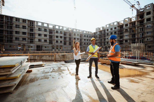 istock Image of full length models - engineers on construction site 1366394326
