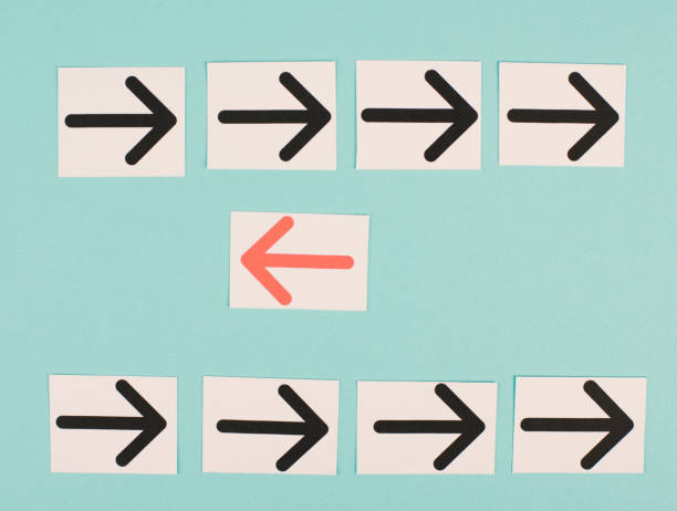 istock Many black arrows, one red is standing out, do different, be a winner, individuality, making your own decision, leadership 1366394357