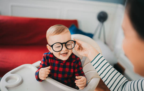 mom plays with glasses and with her baby - glasses child cute offspring imagens e fotografias de stock