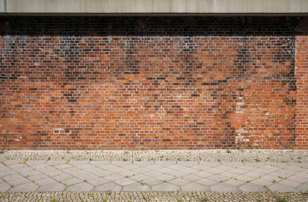 istock Old red brick wall and sidewalk as background image 1366394362
