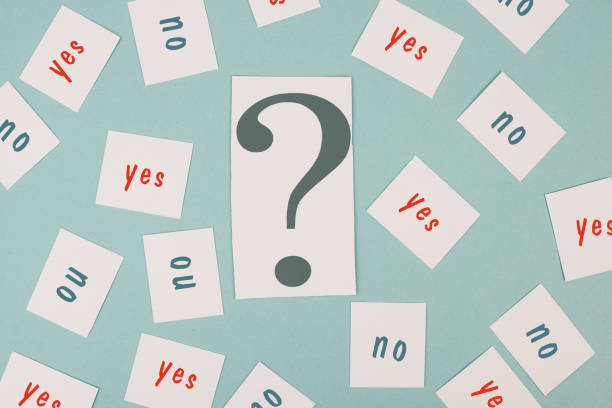 istock Question mark in the middle, yes and no is standing on papers, looking for an answer, asking for a solution, brainstorming about a decision 1366395737