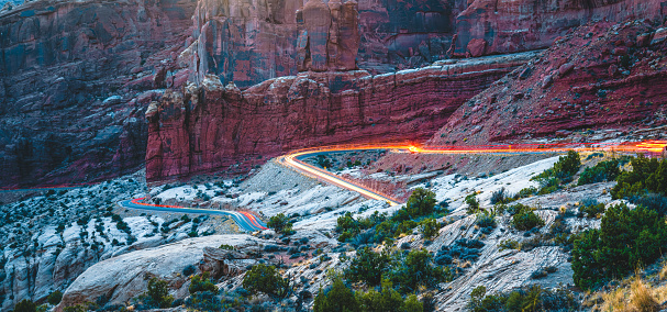 Aerial view at the entrance to the Arches National Park showing glowing car tracks inUtah, USA. Images took with long exposure at the golden hours in the evening.