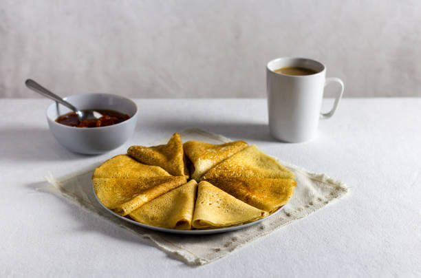 istock pancakes with jam on a light background. Side view, vertical orientation. light textile 1366396566