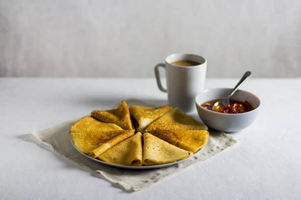pancakes with jam on a light background. Side view, vertical orientation. light textile