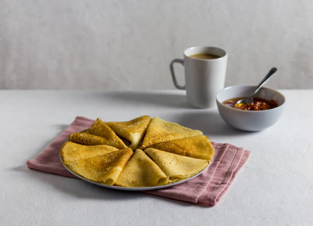istock pancakes with jam on a light background. Side view, vertical orientation. pink textile 1366396578
