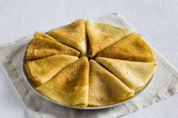 istock pancake on a light background. close-up ,Side view, vertical orientation. light textile 1366396581