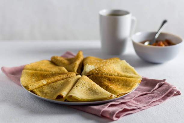 istock pancakes with jam on a light background. Side view, vertical orientation. pink textile 1366396582