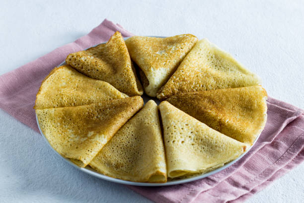 pancake on a light background. close-up ,Side view, vertical orientation. pink textile