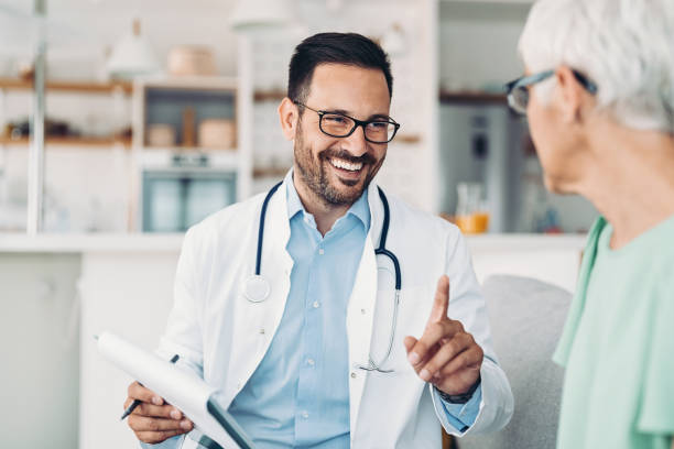 istock Smiling doctor advising a senior patient 1366398806