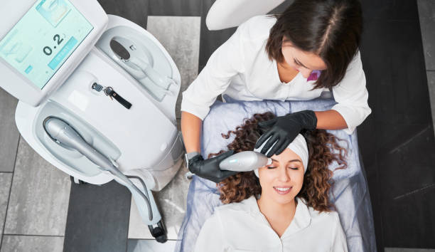 istock Cosmetologist making vacuum hydro peeling for patient. 1366398866