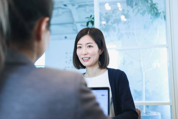 istock Two diverse ethnicity business people discussing in a conference room. 1366399278