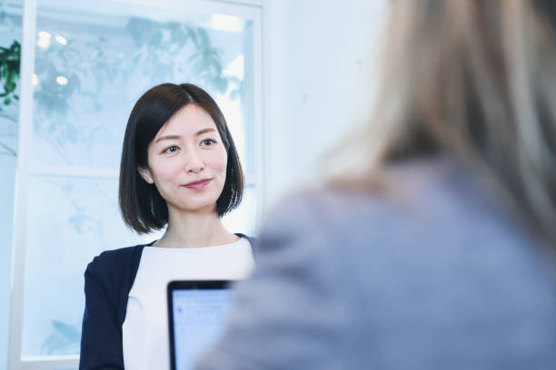 istock Two diverse ethnicity business people discussing in a conference room. 1366399324