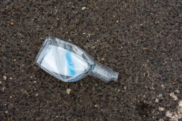 an empty plastic bottle with a view from above on a street