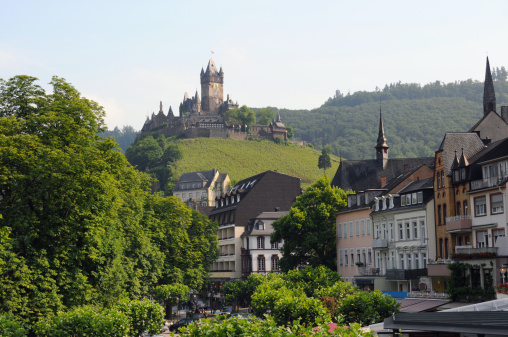 Cityscape of Cochem with typical house and vineyards. 
