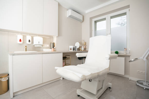 istock Interior of white beauty parlor with specialized couch for cosmetic procedures and professional equipment with furniture. 1366400755
