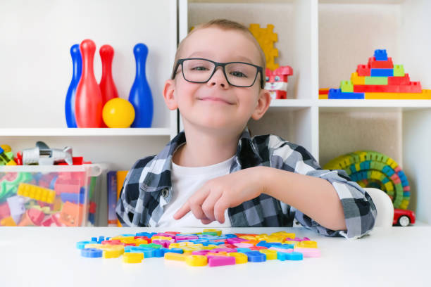 istock speech therapy. Toddler boy with letters. 1366404188