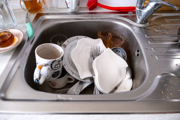 istock Ordinary Sink Full Of Dirty Dishes 1366404372