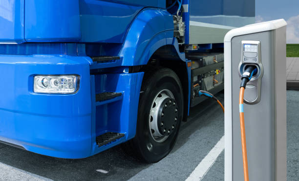 Electric truck with charging station stock photo