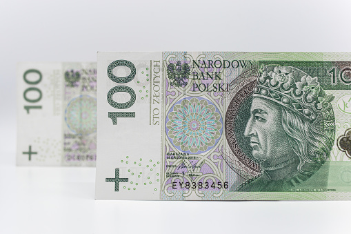 Polish currency on a white background arranged in a pattern. Illustrates cash flow and business