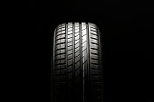 beautiful new summer tire on a black background. summer protector against aquaplaning and fuel economy