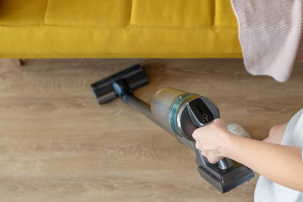 Hand hold vacuum cleaner on white background