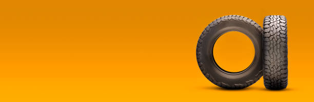 new all-season at tires on an orange background. a long empty copyspace layout stock photo