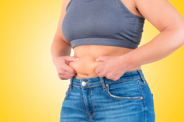 istock Woman squeezing fat abdomen 1366410433