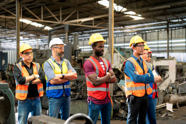 istock Workers and workers are standing in the factory. Group Staff Standing In Engineering Factory. 1366410530