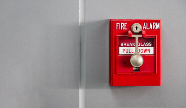 istock An office building's fire alarm switch is mounted on the wall. 1366410619