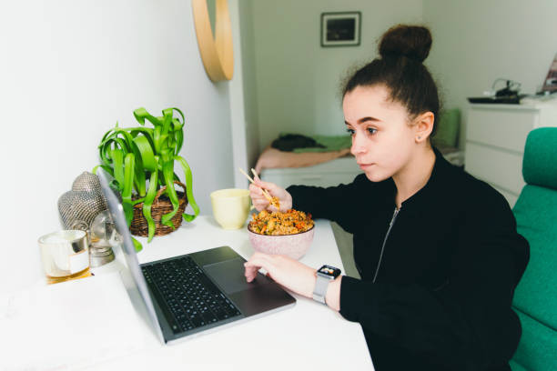 istock Female having dinner with Asian friend rice with seafoodl while studying at home 1366414898
