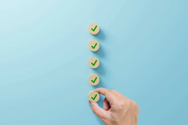istock Checklist and check mark concept. Check mark on wooden blocks on light blue background 1366416292