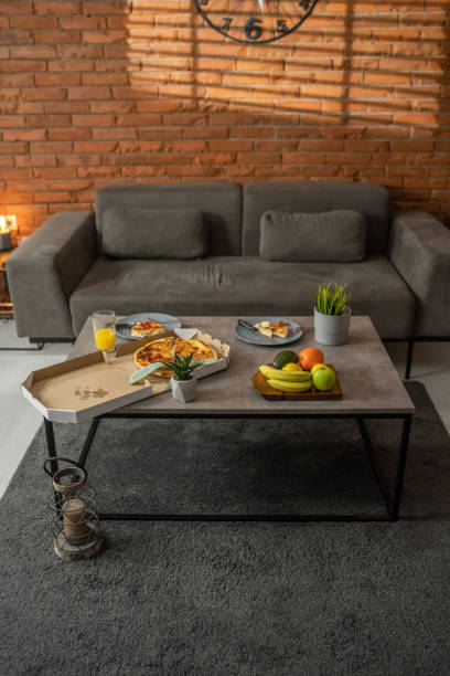 Pizza in pizza box in modern living room in industrial style. No people.