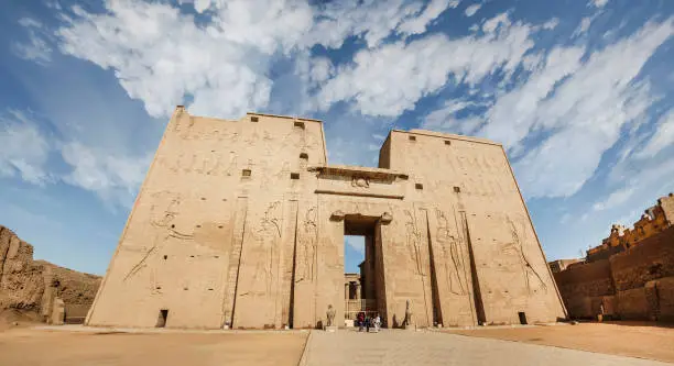 The main entrance of Edfu Temple showing the first pylon, Dedicated to the Falcon God Horus, Located on the west bank of the Nile, Edfu, Upper Egypt
